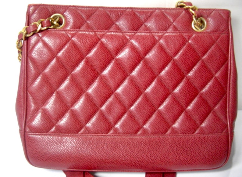 CHANEL Vintage cherry red caviar leather quilted shoulder bag, tote with golden CC ball and chain straps