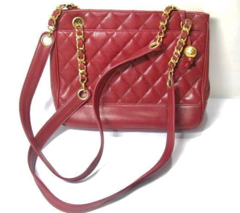 CHANEL Vintage cherry red caviar leather quilted shoulder bag, tote with golden CC ball and chain straps