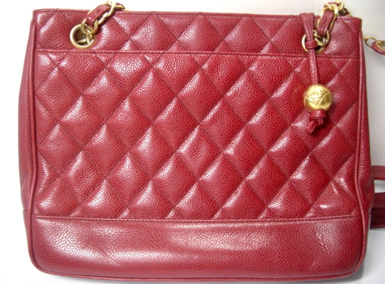 CHANEL Vintage cherry red caviar leather quilted shoulder bag, tote with golden CC ball and chain straps