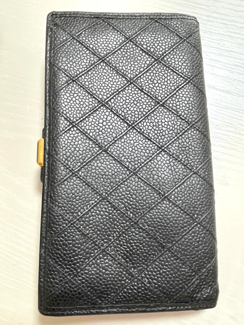 CHANEL Vintage black caviar leather wallet with stitches and gold tone CC motif