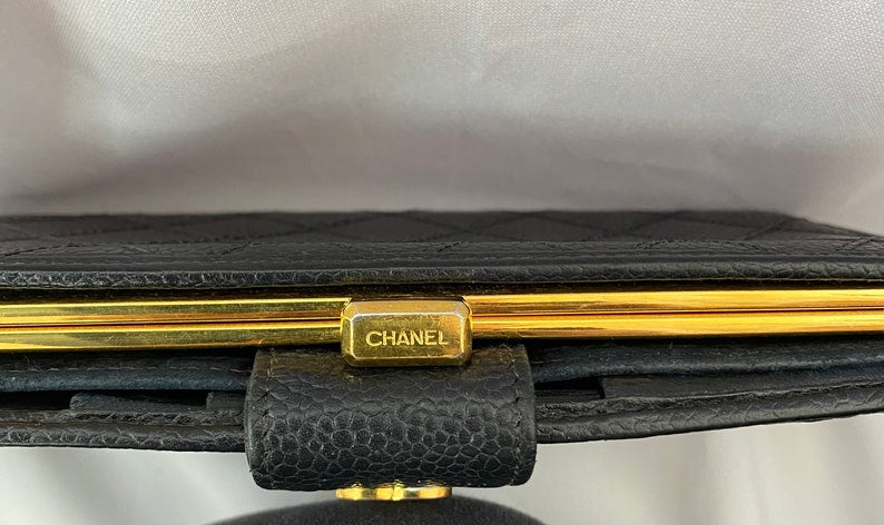 CHANEL Vintage black caviar leather wallet with stitches and gold tone CC motif