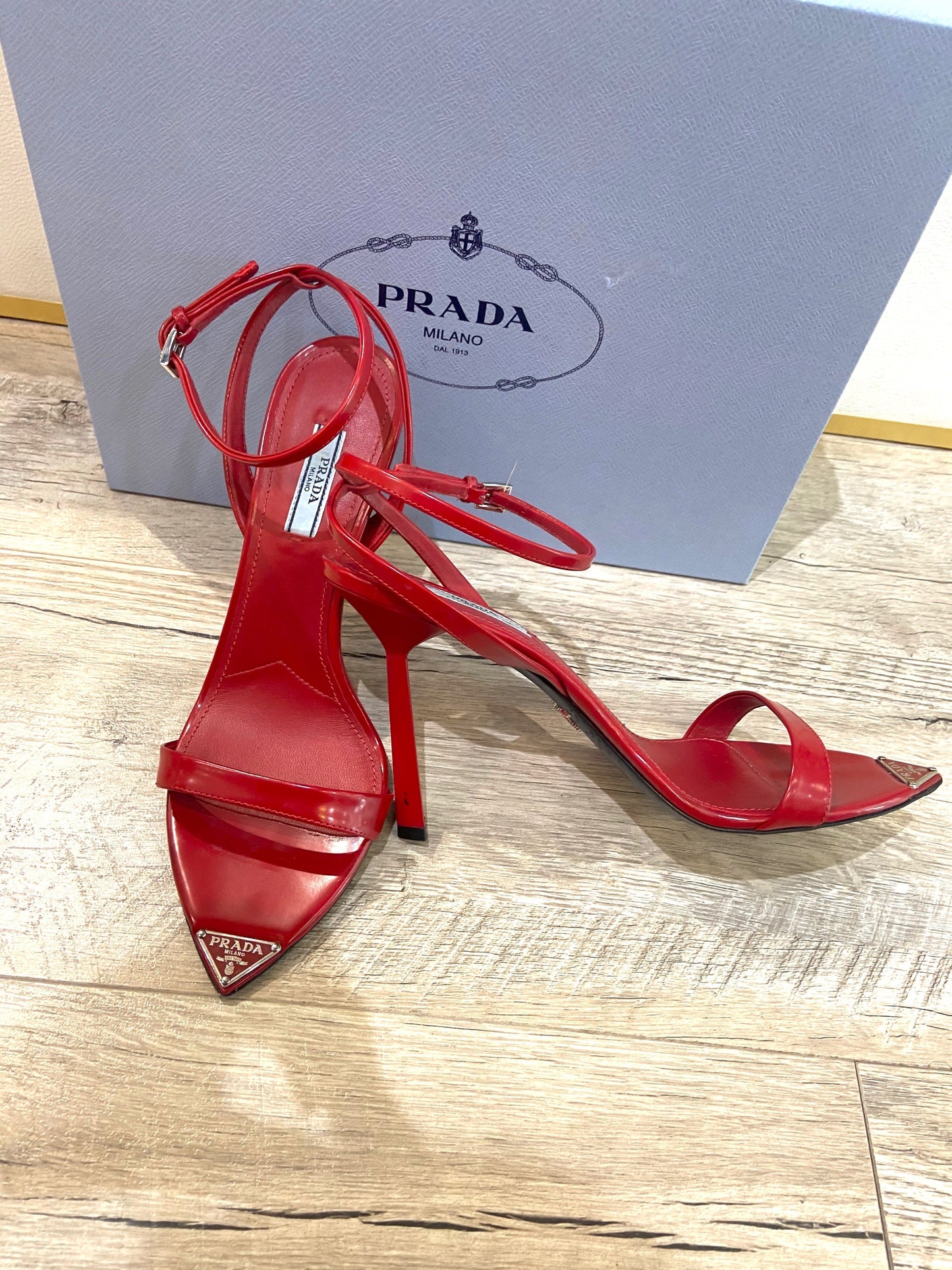 PRADA METALLIC LEATHER HIGH HEEL SANDALS IN SCARLATTO